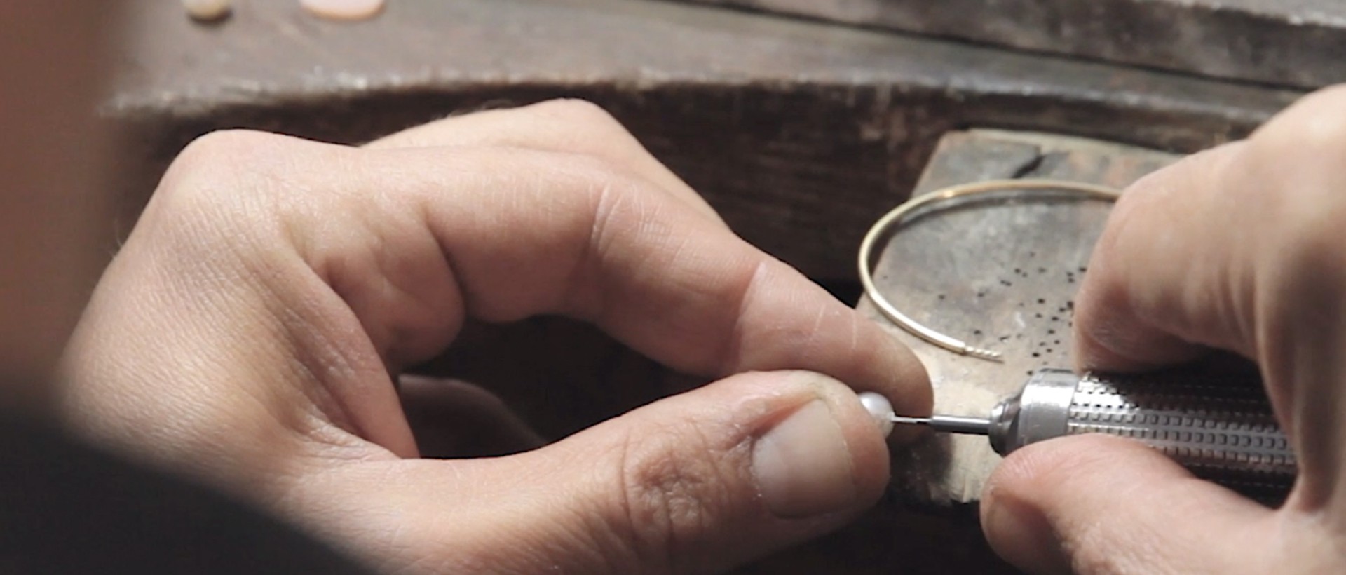 jeweler shaping the jewel with the pearl